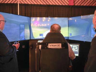 A man operating a driving simulator
